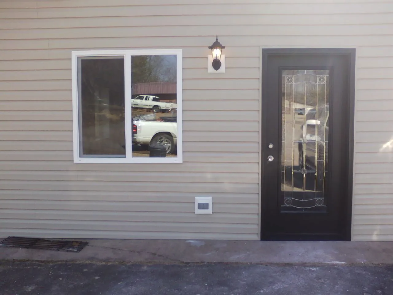 New siding, window and entry door on the side of an addition in Palisades