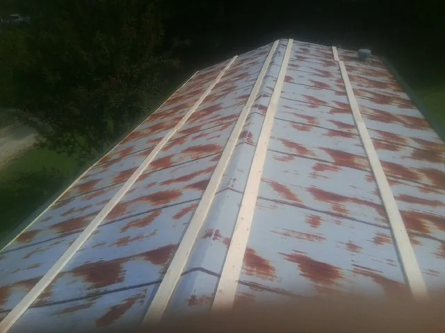 Rusted metal roof panels with new wood purlins before replacement — Storm Damage Roof Repair in Palisades by Roofing Brothers