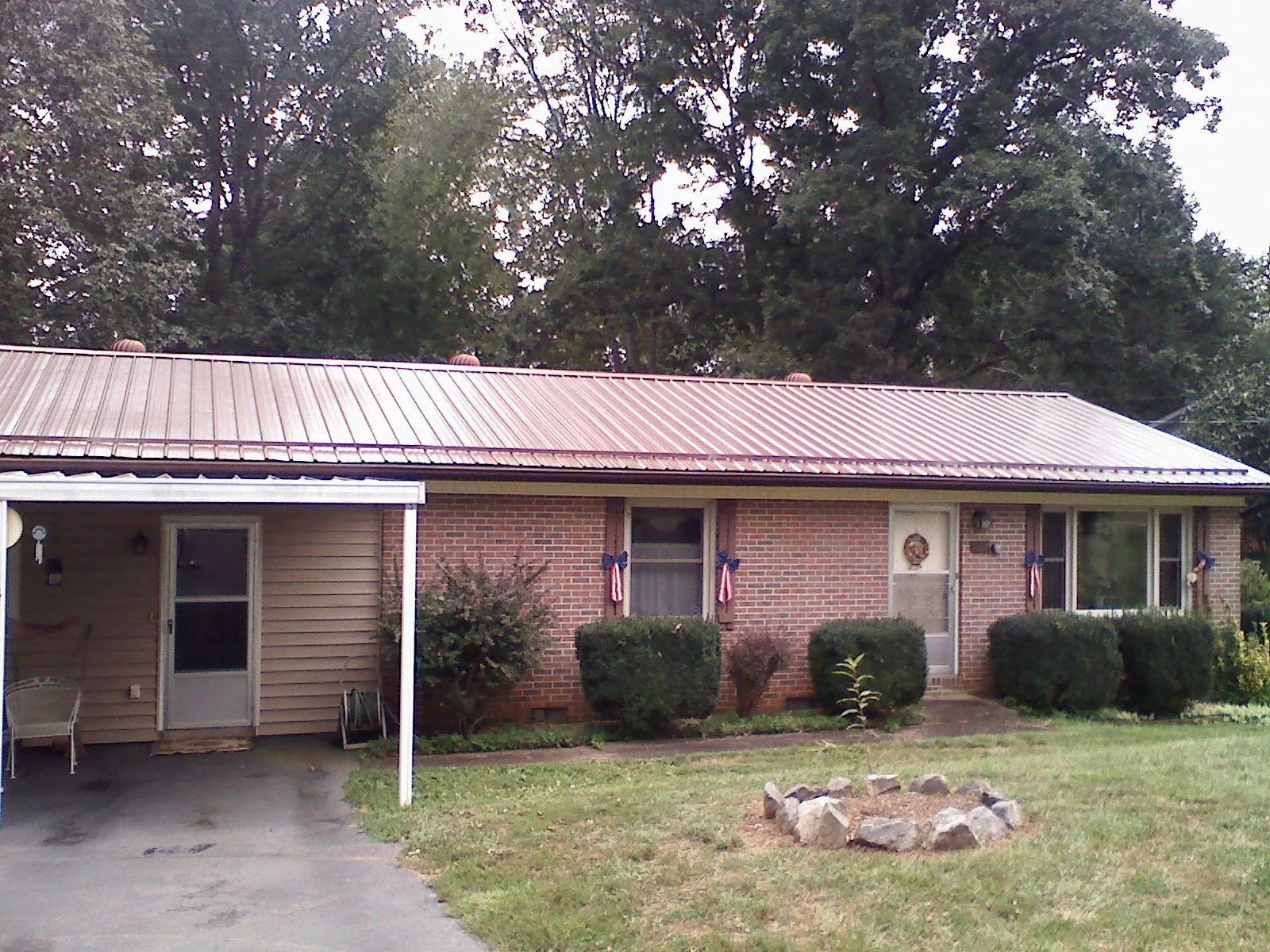Bronze metal roof and carport on a brick ranch home — Roof Repair work by our crew in Palisades